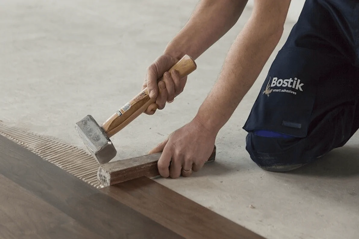 A floorlayer installing LVT