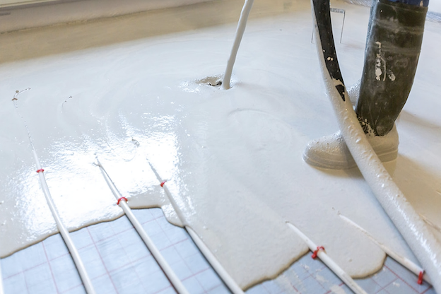 A calcium sulphate screed being applied to a floor